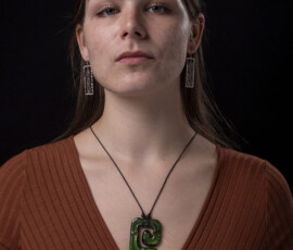 A girl modelling a green rock necklace.
